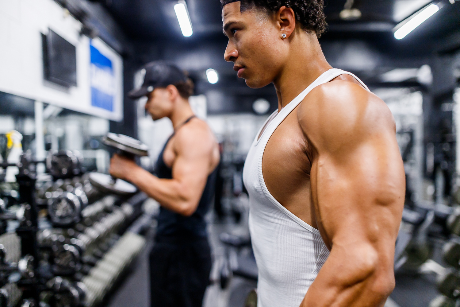 Bodybuilder mid-rep on a dumbbell press