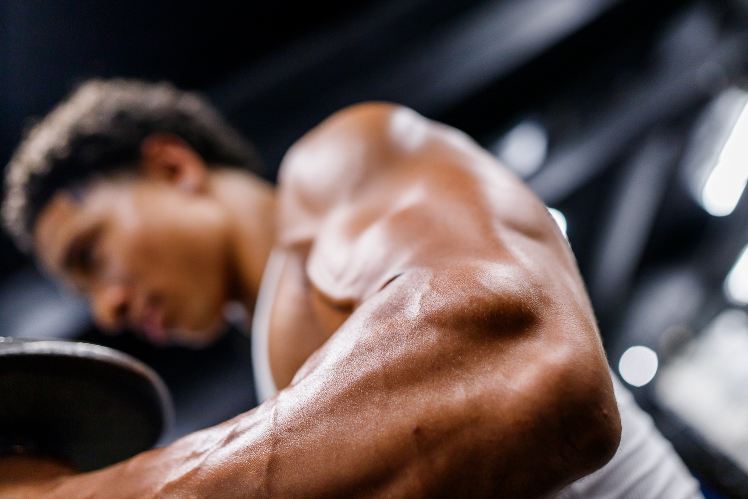Athlete resting between sets, chalked hands